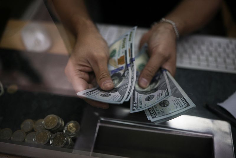 Dollar on back foot as traders eye series of Fed rate cuts