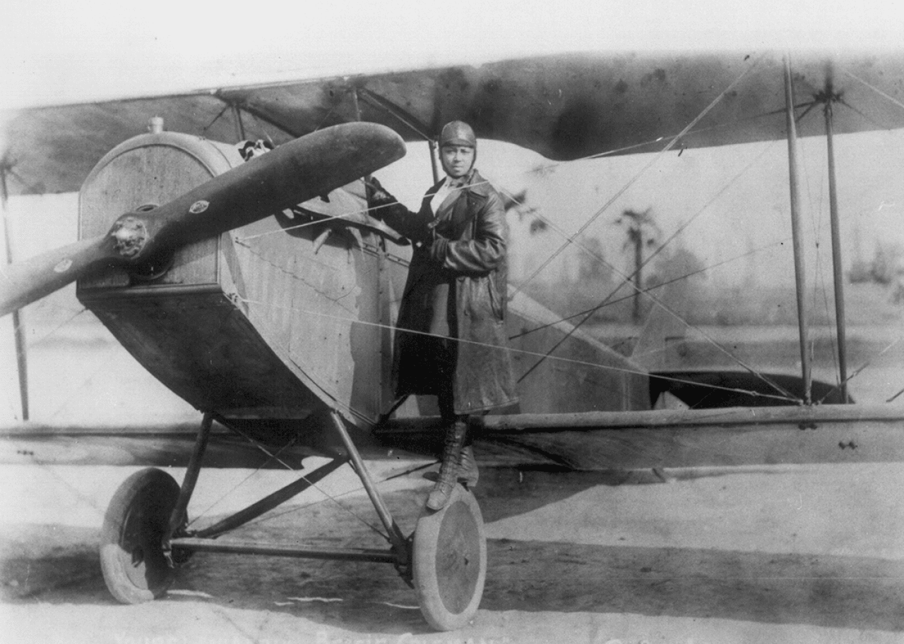 Bessie Coleman Bessie Coleman poses beside her bi-plane.